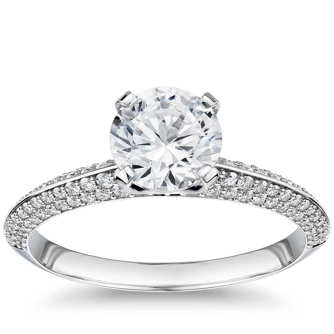 An engagement ring with a single 1-carat diamond and a knife-edge band with rows of micro pavé diamonds.